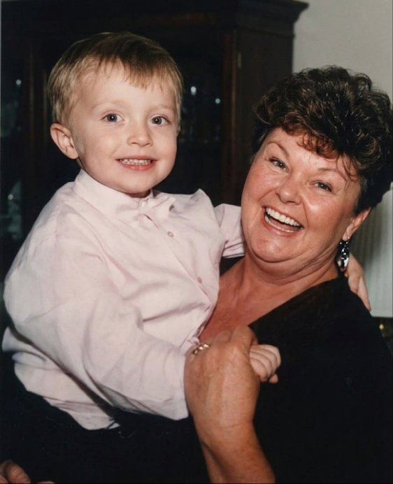 Danielle’s mother smiling with a young family member
